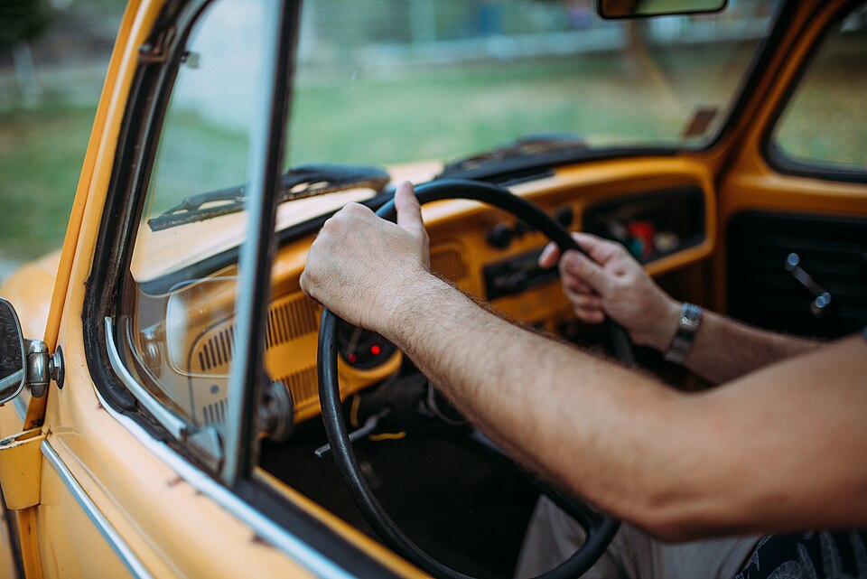 Man in the car holding steering wheel.jpg
