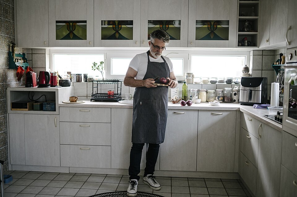 Man prepares vegetables in a modern kitchen.jpg