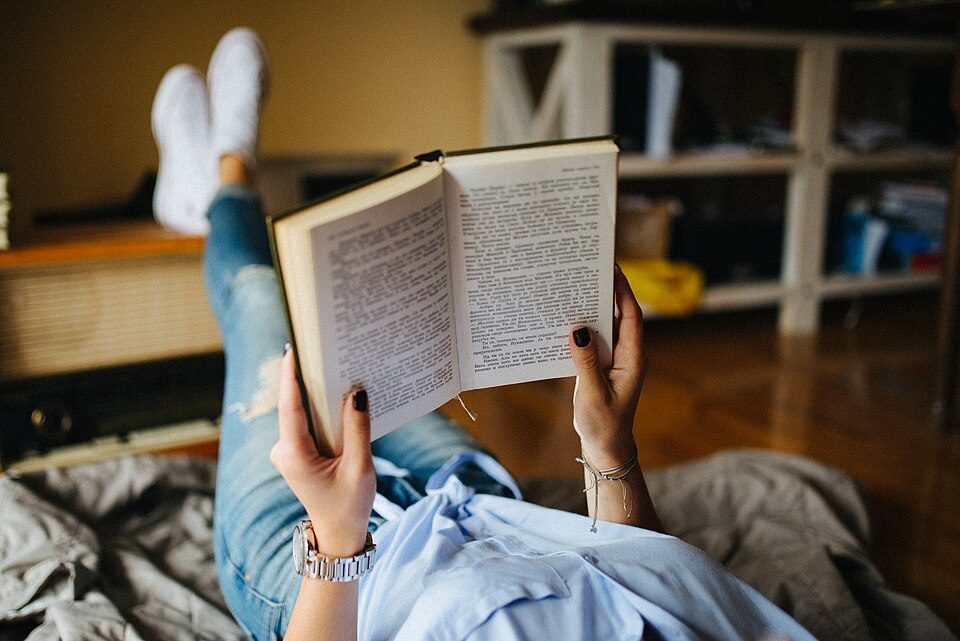 Young woman reading a book closeup.jpg