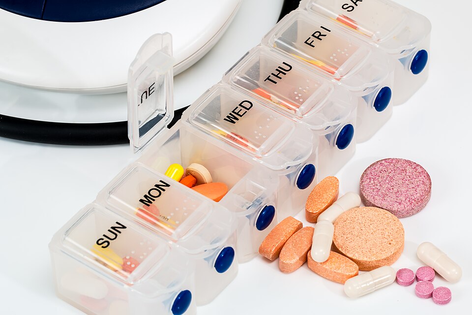Pill Organizer With Vitamins And Medicines.jpg